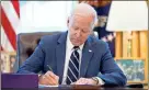  ?? Ap-andrew Harnik ?? President Biden signs the American Rescue Plan.