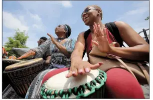  ?? Democrat-Gazette file photo/THOMAS METTHE ?? Denisha Cleaves (right) of Memphis and Shakeenah Kadem (left) of Fort Smith play the drums during the 2018 Africa Day Fest.