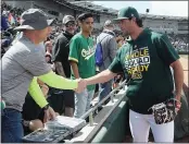  ?? PHOTO BY JOHN MEDINA ?? A’s pitcher Kyle Finnegan interacts with a fan Wednesday before a game against the Chicago Cubs in spring training.