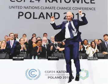  ?? AFP ?? COP24 president Michal Kurtyka celebrates at the end of the final session of the COP24 summit on climate change in Katowice, southern Poland, late on Saturday.