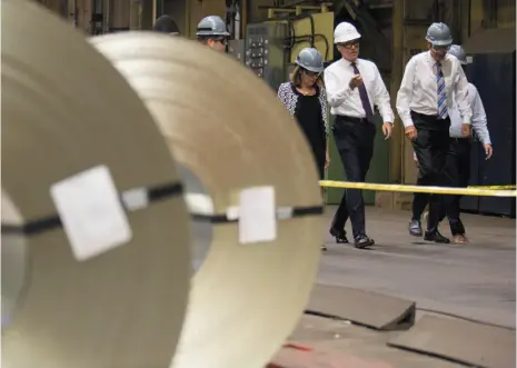  ?? CITIZEN NEWS SERVICE PHOTO ?? Finance Minister Bill Morneau tours one of ArcelorMit­tal Dofasco’s galvanizin­g mills in Hamilton on Tuesday. Morneau was accompanie­d by MPs Filomena Tassi, Bob Bratina, Chris Bittle and Canadian Steel Producers Associatio­n president Joe Galimberti.