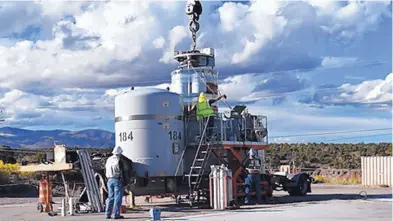  ?? DEPARTMENT OF ENERGY ?? Los Alamos waste management staffers prepare a waste shipment for transport to WIPP.