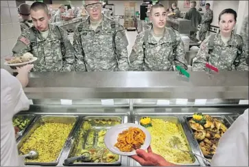  ?? Robert Cohen St. Louis Post-Dispatch ?? ARMY TRAINEES have three levels of labeled food choices in an effort to improve their fitness as they traverse the serving line inside the dining hall at Ft. Leonard Wood in Missouri in 2011.