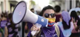  ?? CARLOS GIUSTI AP ?? Women protest Monday in San Juan against what they say is the Puerto Rican government’s slow response to violence against women.