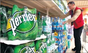  ?? BLOOMBERG ?? Perrier bottled water, produced by Nestle SA, is popular at most grocery stores.