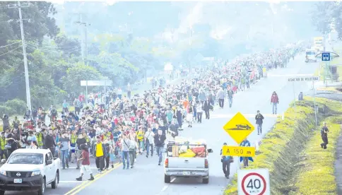  ??  ?? Honduran migrants take part in a caravan heading to the US on the road linking Ciudad Hidalgo and Tapachula, Chiapas state, Mexico. — AFP photos