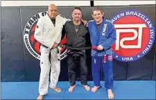  ?? Contribute­d ?? Rome High School teacher Nat Bomar (center) recently earned his black belt in Brazilian jiujitsu.