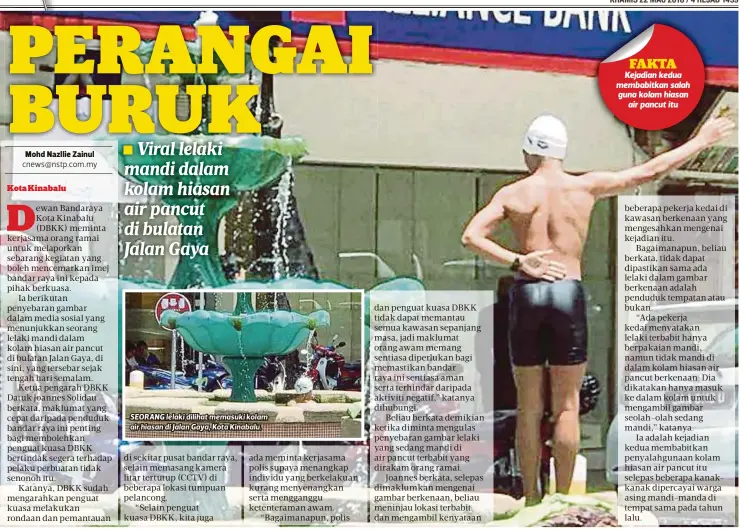  ??  ?? SEORANG lelaki dilihat memasuki kolam air hiasan di Jalan Gaya, Kota Kinabalu.