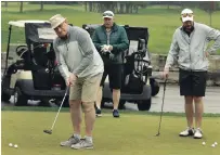  ?? CLIFFORD SKARSTEDT EXAMINER FILE PHOTO ?? Bob Gainey takes a practice putt next to Paul MacIntosh and Jeremiah MacKenzie at the annual Jack's Peterborou­gh and District Sports Hall of Fame Golf Tournament on May 23, 2019.