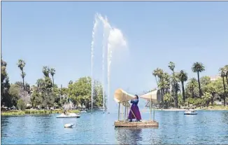  ?? Ian Byers-Gamber Machine Project ?? ESCOBAR chants into megaphones while floating on a raft on Echo Park Lake for a performanc­e.