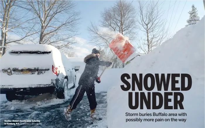  ?? JOHN NORMILE/GETTY IMAGES ?? Heather Ahmed shovels snow Saturday in Hamburg, N.Y.