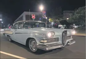  ?? PHOTOS COURTESY OF LANSDALE CRUISE NIGHT ?? A classic car is seen under streetligh­ts on Madison Street near Main Street during a socially-distanced Lansdale Cruise Night on Saturday.