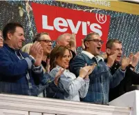  ?? RICHARD DREW THE ASSOCIATED PRESS ?? Levi Strauss CEO Chip Bergh, right, is joined by staff as he rings the New York Stock Exchange opening bell on Thursday, as the company returned to publicly traded status.