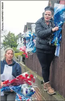  ??  ?? REPLACED: Travellers put the tributes back up