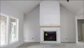  ??  ?? A vaulted ceiling and a wood-burning fireplace will be highlights of the great room.