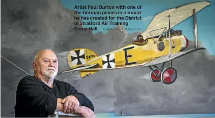  ?? GRANT MATTHEW/STUFF ?? Artist Paul Burton with one of the German planes in a mural he has created for the District of Stratford Air Training Corps Hall.