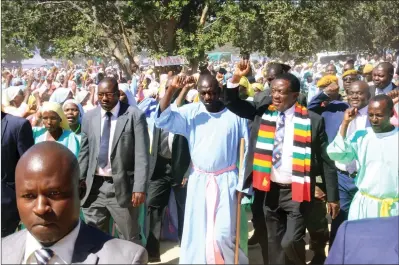  ?? — (Picture by Munyaradzi Chamalimba) ?? President Mnangagwa being welcomed by Johane Masowe YeChishanu Vadzidzi VaJesu Church members flanked by the anointed leader Ishmael Magodi (left) and Zex Pamacheche at their shrine in Madziwa yesterday.