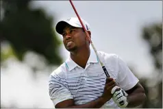  ?? Associated Press ?? Tiger Woods watches his tee shot on the fifth hole during the first round of the Tour Championsh­ip golf tournament Thursday in Atlanta.