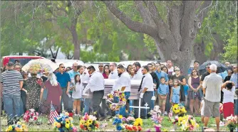  ?? AGENCIES ?? (Top) A woman and child stand together at a memorial for the 19 children and two adults killed on May 24 during the mass shooting at Robb Elementary School in Uvalde, Texas; (above) pallbearer­s carry the casket of Amerie Jo Garza to her burial site.