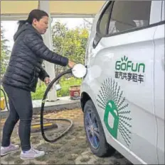  ?? GETTY IMAGES ?? China plans to build more than 12,000 charging stations before 2020 for more than five million new electric vehicles.