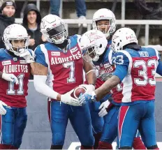  ?? GRaHAM HUGHES/CP ?? Montreal’s John Bowman celebrates with his Alouette teammates after scoring a TD during the second half of Sunday’s game against the Argos at Molson Stadium. The Als won handily, 40-10.