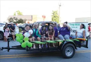  ?? ELISHA MORRISON/ The Saline Courier ?? Girl Scout Troop 6035 rides a float along the route of the 2018 Saline County Fair Parade in Downtown Benton. This year’s midway kickoff will take place Sept. 3.