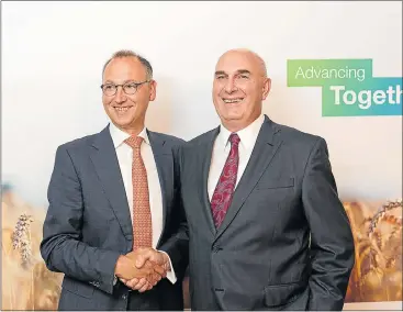  ?? Picture: EPA ?? RISING GIANT: A handout image released by Bayer showing Werner Baumann, left, CEO of Bayer, and Hugh Grant, chairman and CEO of Monsanto, posing for a photo last week. The companies claim the overlaps between their businesses are minimal. VINICY CHAN,...
