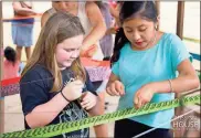  ?? / Mission House Partners Internatio­nal ?? Lilly Tyson (left) learns how to create a handmade hammock from a local girl during the HBC Rome mission trip to San Francisco, Mexico, in late December.