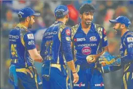  ?? AFP ?? Mumbai Indians’ Jasprit Bumrah (second from right) is congratula­ted by teammates after taking the wicket of Sunrisers Hyderabad’s Rashid Khan in Mumbai on Wednesday.