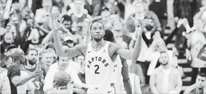  ?? NATHAN DENETTE THE CANADIAN PRESS ?? Toronto Raptors forward Kawhi Leonard reacts following the Raptors win against the Milwaukee Bucks in Game 3 of the NBA Eastern Conference finals in Toronto on Sunday. Leonard, who normally does not play many minutes due to injury, was very effective.