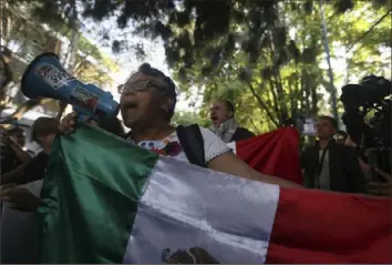  ?? Ginnette Riquelme/Associated Press ?? People protest outside the Ecuadorian Embassy in Mexico City, Saturday. Mexico’s government has severed diplomatic ties with Ecuador after police broke into the Mexican Embassy to arrest a former Ecuadorian vice president.