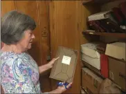  ??  ?? Eileen Kinsella looks over documents of the Hazel Carpenter Adult Home to go to the Madison County Historical Society on Wednesday, Aug. 7.