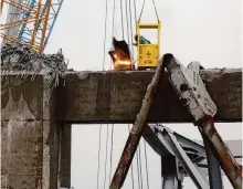  ?? Chip Somodevill­a/getty Images ?? Salvage personnel work Tuesday to clear the wreckage of the Francis Scott Key Bridge in Baltimore. A tugboat late Monday was the first to use an alternate channel to bypass the wreckage.