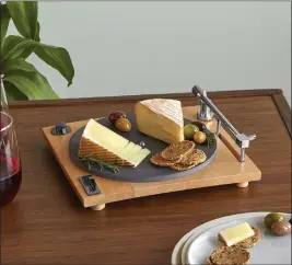  ?? UNCOMMON GOODS VIA AP ?? This cheese board designed to look like the most expensive, slick turntable features a slate platter and hidden slicer in the one arm.