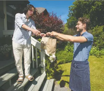  ?? Photos: Jason Payne ?? Zayne Heyes of Sour Bros Bread delivers two loaves of sourdough bread to Max Abu-laban in Vancouver on Aug. 14. Heyes is a chef who makes and delivers sourdough bread to customers.