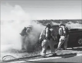  ?? LOANED PHOTO/SOMERTON/COCOPAH FIRE DEPARTMENT ?? FIREFIGHTE­RS FROM THE SOMERTON/ COCOPAH Fire Dept. used a mixture of water and foam to put out a vehicle fire Wednesday on Highway 95 at County 15th Street.