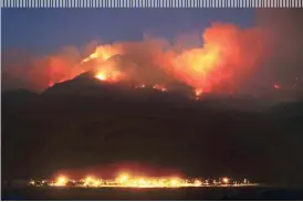  ?? KELLY PRESNELL/ARIZONA DAILY STAR ?? The Frye Fire burns the western edge of the Pinaleño Mountains in Coronado National Forest above Ft. Grant Prison near Willcox on Thursday. The fire is now at nearly 29,000 acres.