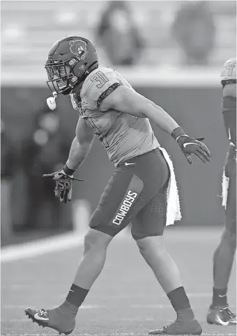  ?? [SARAH PHIPPS/ THE OKLAHOMAN] ?? Oklahoma State's Kolby Harvell-Peel celebrates a play during the Cowboys' win over Iowa State last Saturday.