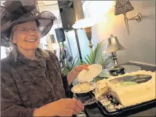  ?? THE NEWS ?? Host Sandy Guadagni serves a commemorat­ive cake to guests at 135 Provost Street on May 19.