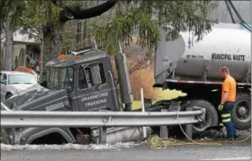  ?? MARIAN DENNIS – DIGITAL FIRST MEDIA ?? Part of Route 73 in Colebrookd­ale Township was shut down Tuesday morning after a tractor trailer left the road and got stuck in an embankment. The driver suffered a cut to the head and was transporte­d to Pottstown Hospital.