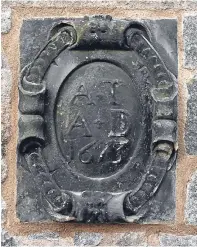  ??  ?? The armorial panel, dating back to 1673, in the wall