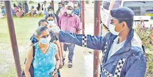  ?? Picture: BALJEET SINGH ?? Police officer Ravikash Deo records Sharmila Devi’s temperatur­e during the vaccinatio­n drive at Lovu Sangam School in Lautoka.