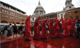  ?? Photograph: Chris J Ratcliffe/Getty Images ?? Protesters cover Paternoste­r Square in central London in fake blood and coins during an Extinction Rebellion march on Friday.