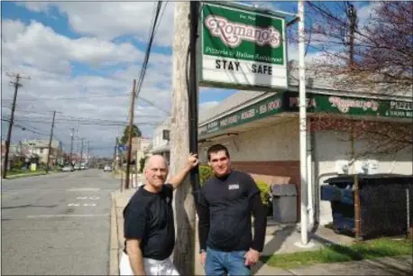  ?? JACK MCCAFFERY - MEDIANEWS GROUP ?? In the family tradition dating to the Depression, president Pete Romano, left, and general manager Barry Wilson of Romano’s pizzeria and restaurant in Essington are successful­ly navigating through a crisis.