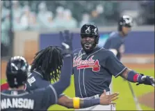  ?? ERIC GAY — ASSOCIATED PRESS ?? The Atlanta Braves’ Marcell Ozuna celebrates after scoring in the third inning of Thursday’s NLDS game against the Miami Marlins in Houston.