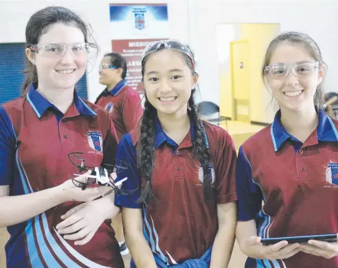  ??  ?? VERSATILE CRAFT: Bentley Park College students Regan Cooper-Swain, Katrina Xiong and Kayla Lucchesi-Jenke learn about drones.