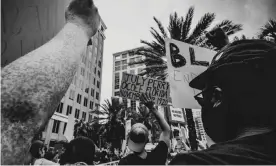  ??  ?? A protester holds up a sign for July Perry who was lynched 100 years ago in the Ocoee massacre in Ocoee, Florida. Photograph: Photo by Melissa Procko, courtesy of Orange County Regional History Center.