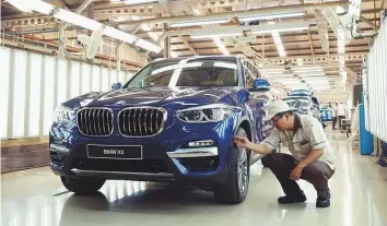  ?? Bloomberg ?? ■ A BMW AG X3 sport utility vehicle is inspected on the production line in Jakarta. BMW’s quarterly revenues declined nearly three per cent despite record deliveries.