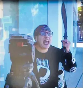  ?? Associated Press ?? IN THIS image released by the L.A. County Sheriff's Department, a woman later identified as Maricia Medrano is shown waving a machete outside Dash boutique.