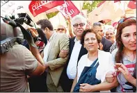  ??  ?? Tunisian lawyer and human rights defender Radhia Nasraoui (second right), and her husband, the Front Populaire party’s spokesman, Hamma Hammami (center), take part in a demonstrat­ion against a controvers­ial economic reconcilia­tion bill that was...